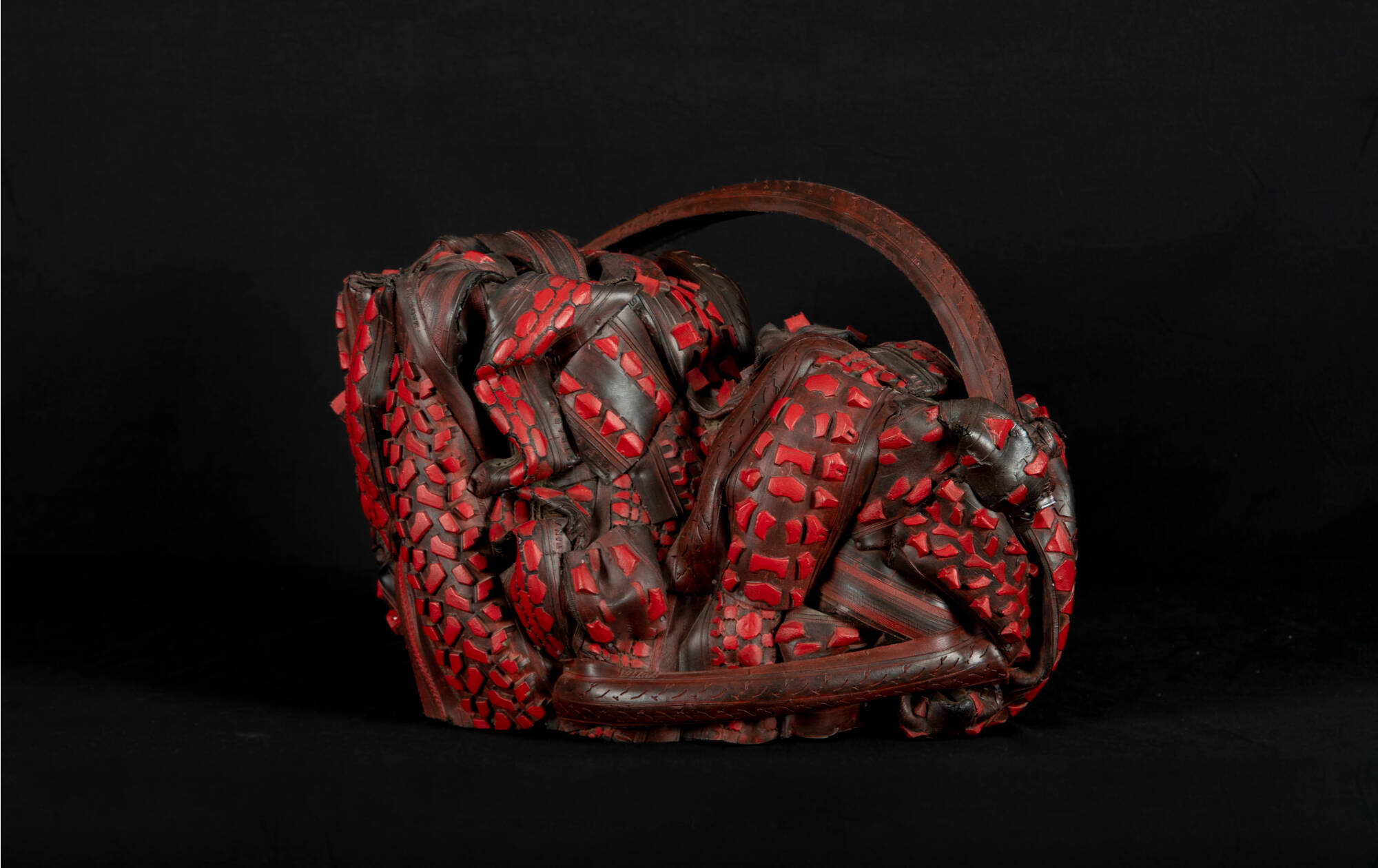 Sculpture made of recycled rubber tires and painted red.
